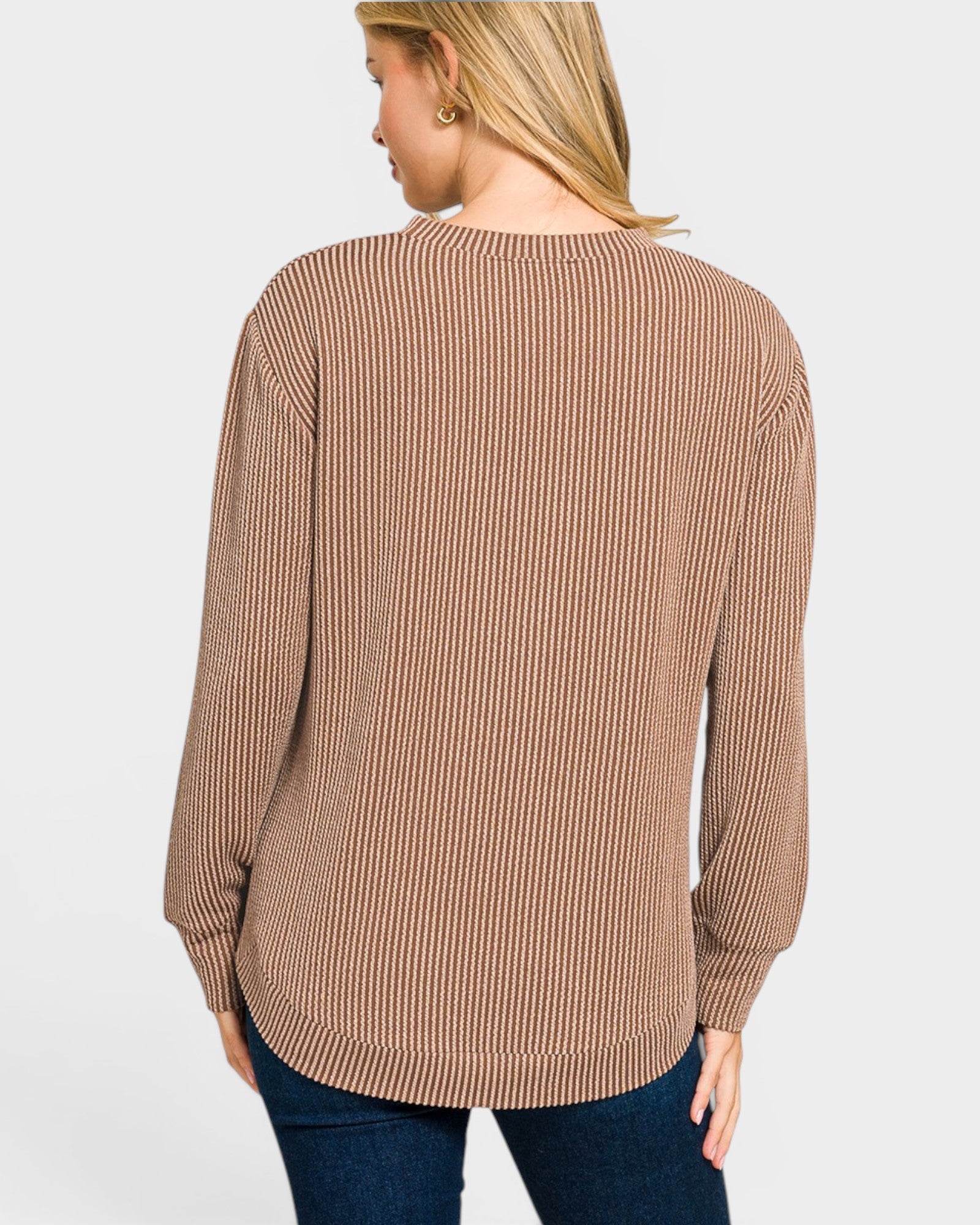 Woman wearing a brown and beige striped long-sleeve top on a white background