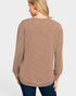 Woman wearing a brown and beige striped long-sleeve top on a white background