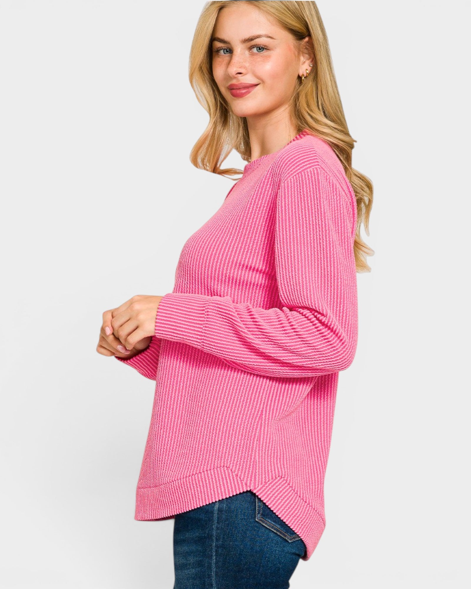 Woman wearing a pink sweater on a white background