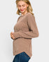 Woman wearing a brown ribbed sweater on a light gray background