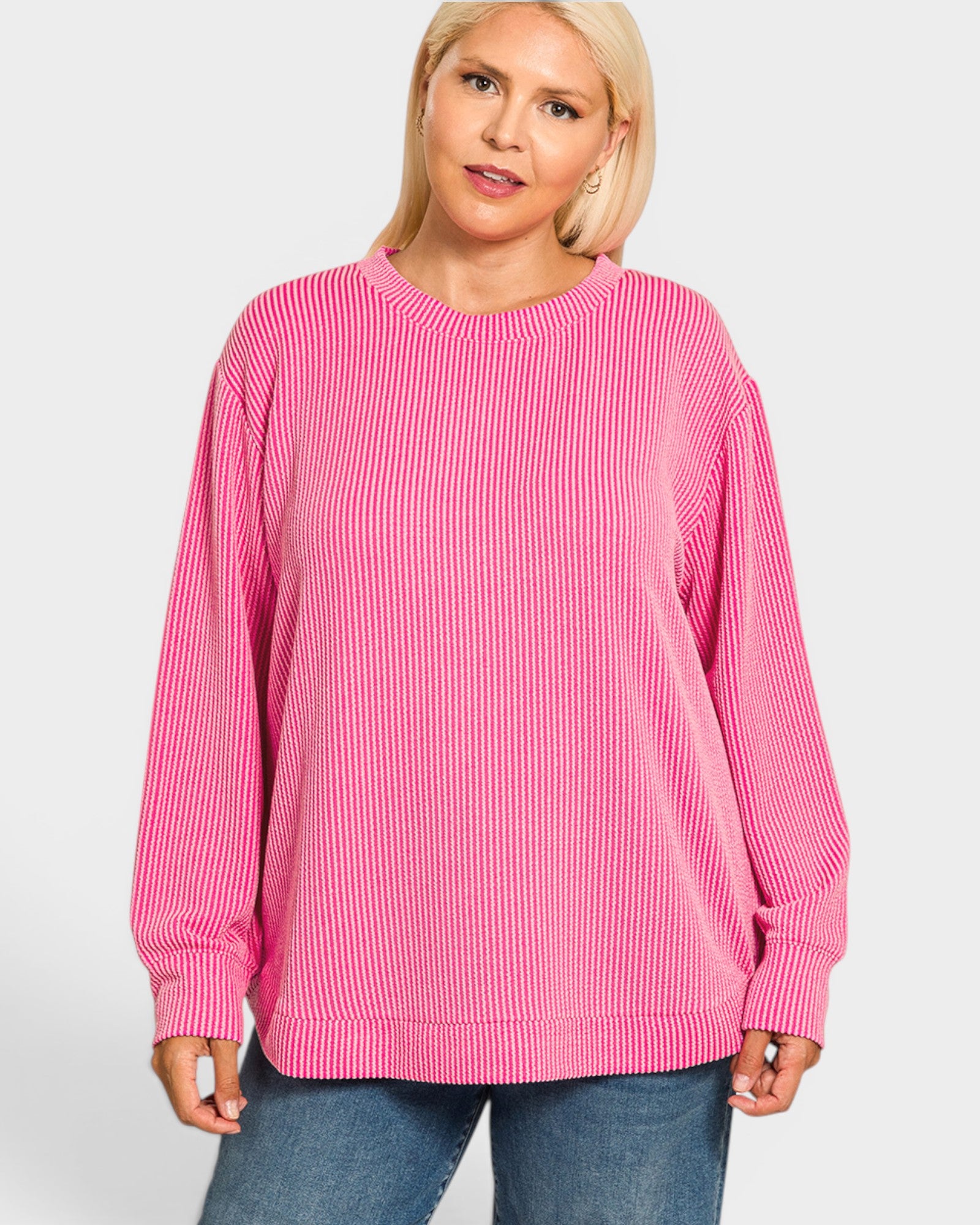 Woman wearing a pink striped sweater on a white background