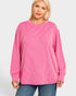 Woman wearing a pink striped sweater on a white background