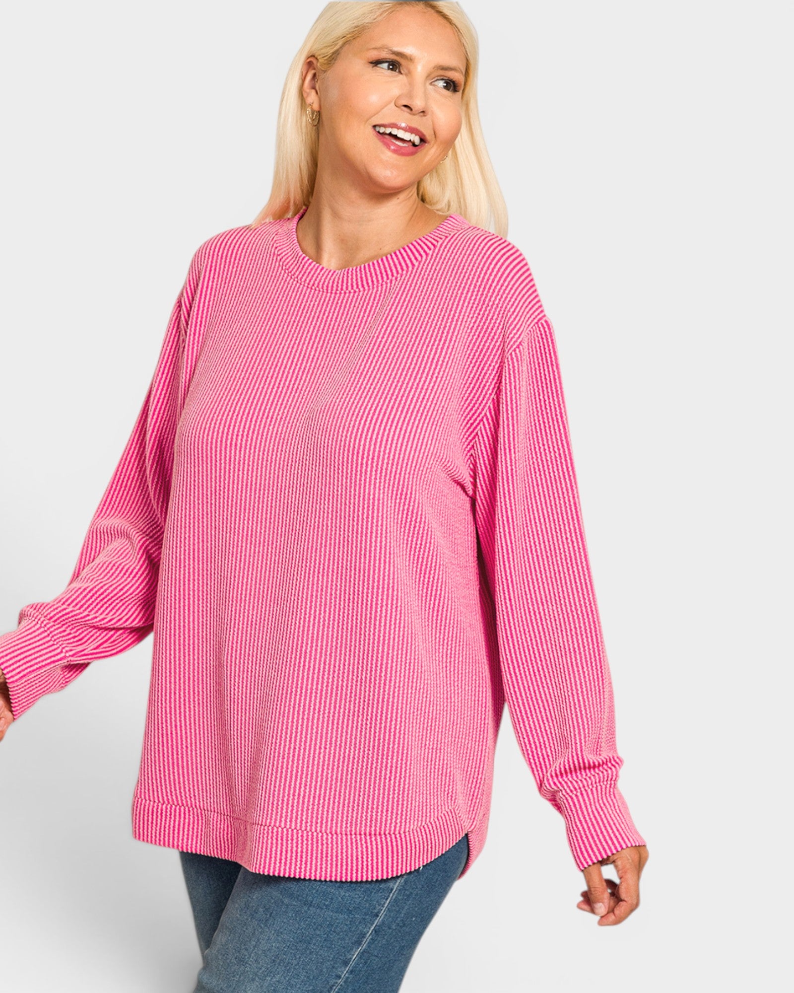 Woman wearing a pink sweater on a white background