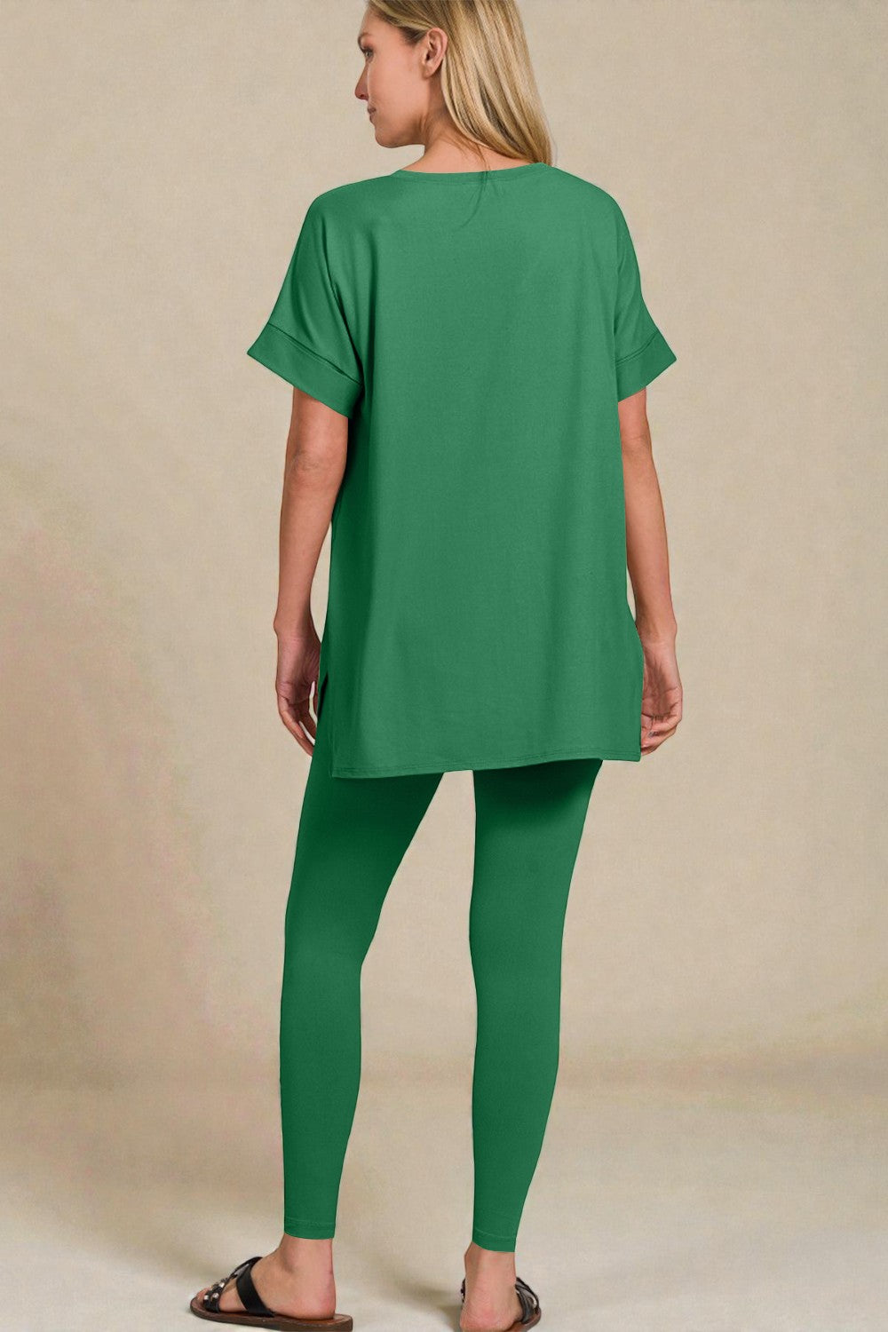 Person wearing a green outfit on a beige background