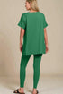 Person wearing a green outfit on a beige background
