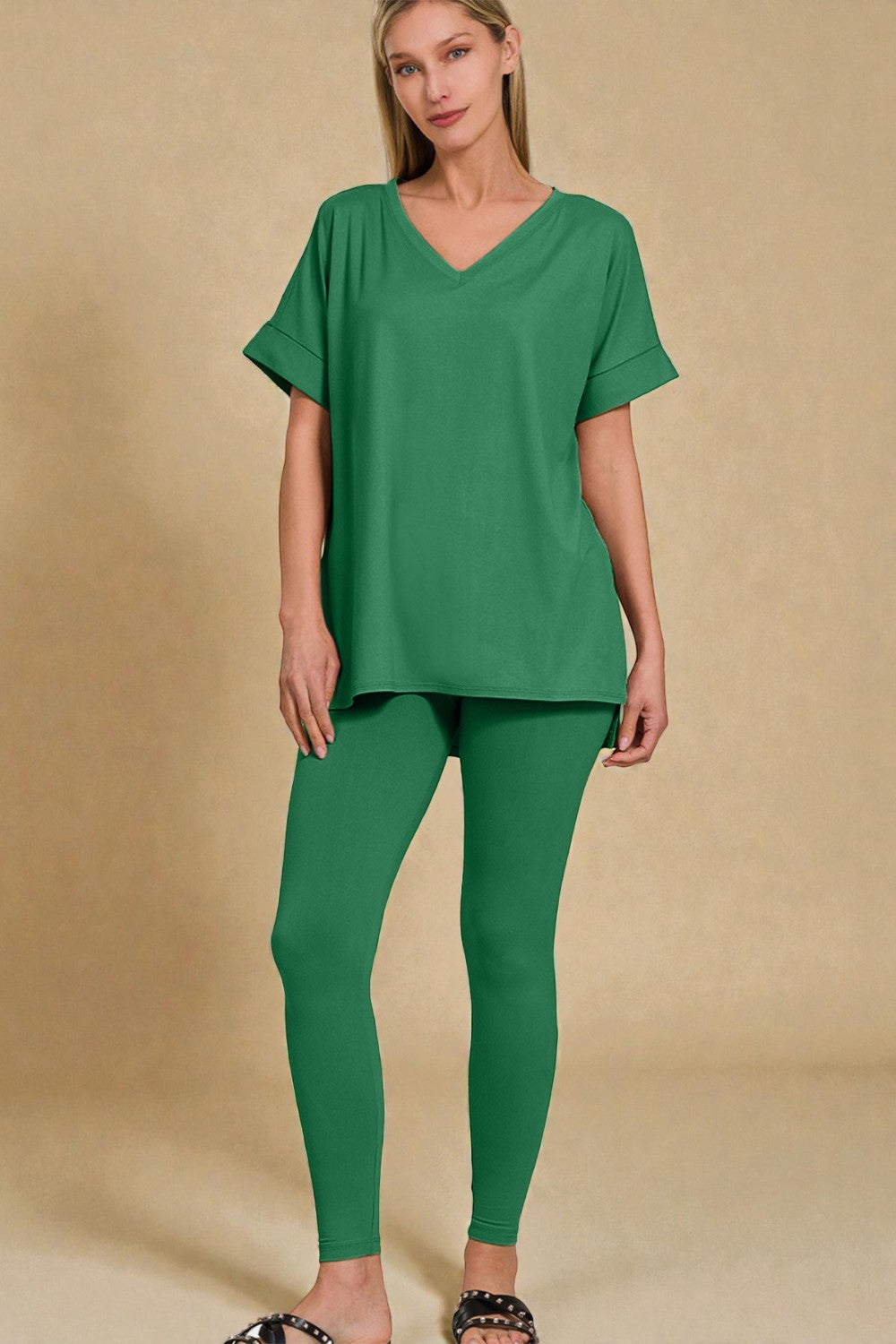 Woman wearing a green outfit on a beige background