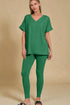 Woman wearing a green outfit on a beige background