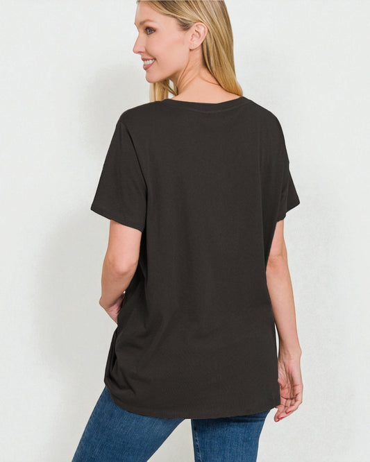 Woman wearing a black t-shirt and blue jeans on a white background