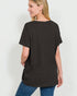 Woman wearing a black t-shirt and blue jeans on a white background