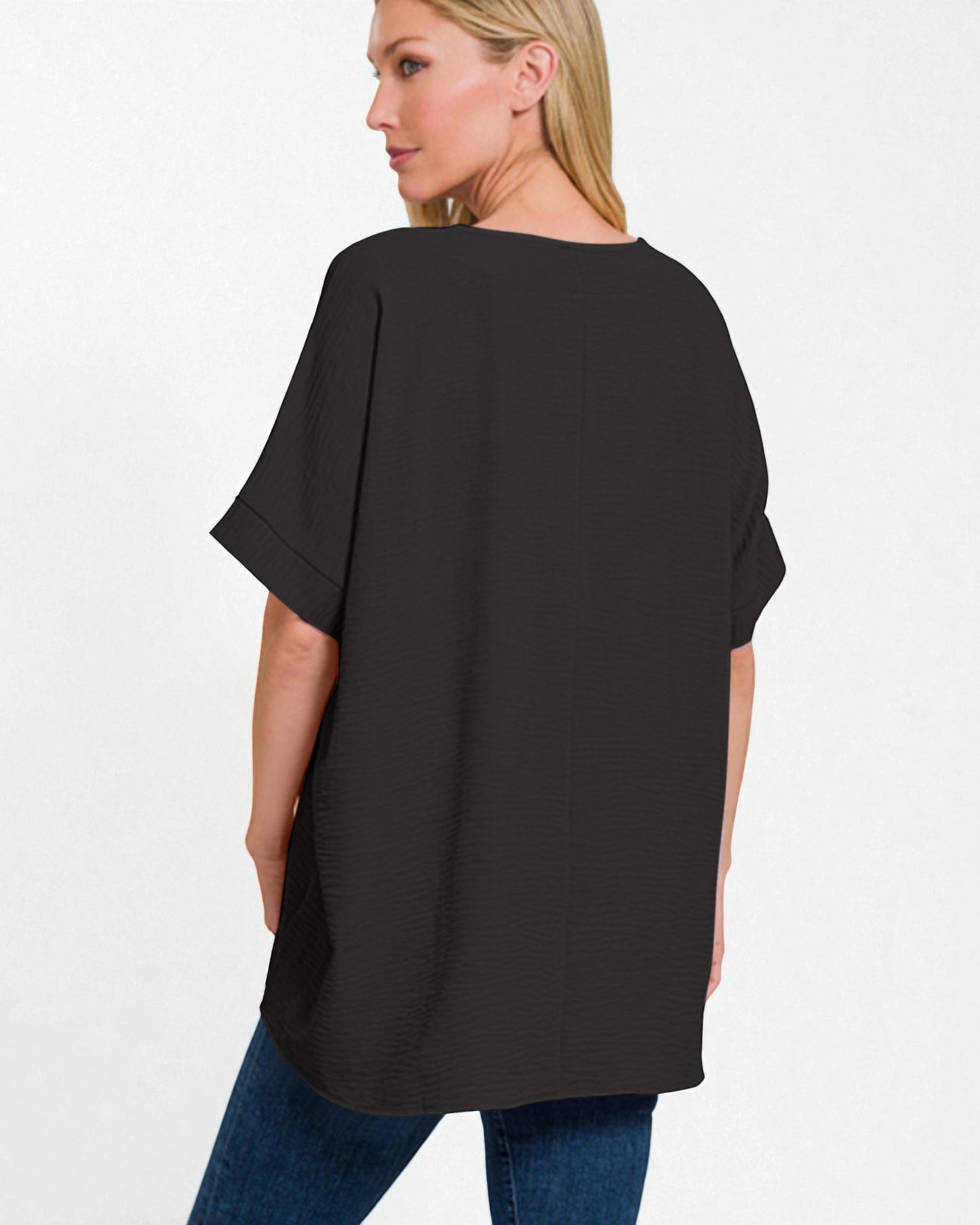 Woman wearing a black oversized t-shirt on a white background