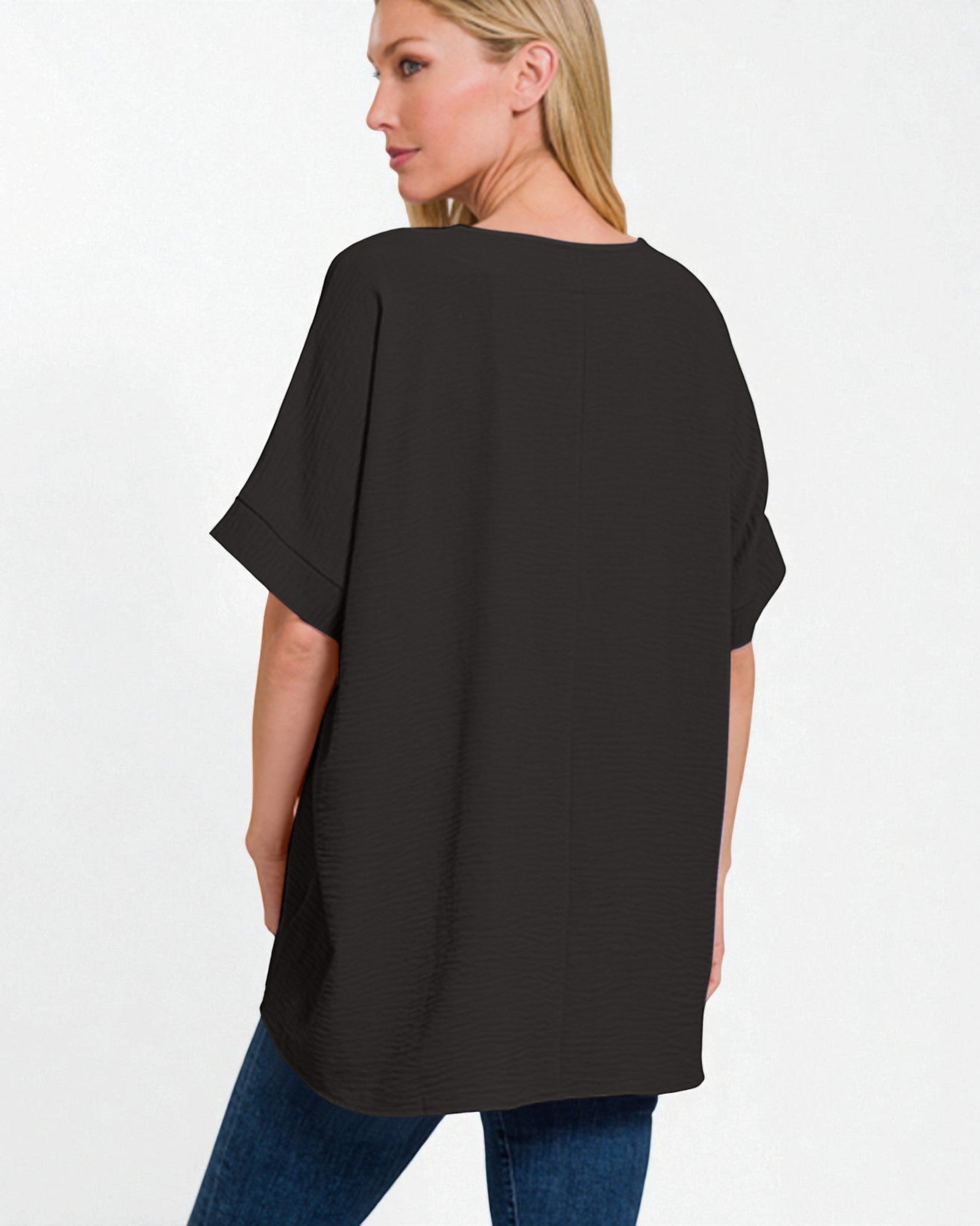 Woman wearing a black oversized t-shirt on a white background