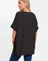 Woman wearing a black oversized t-shirt on a white background
