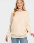 Woman wearing a beige sweater and blue jeans on a white background
