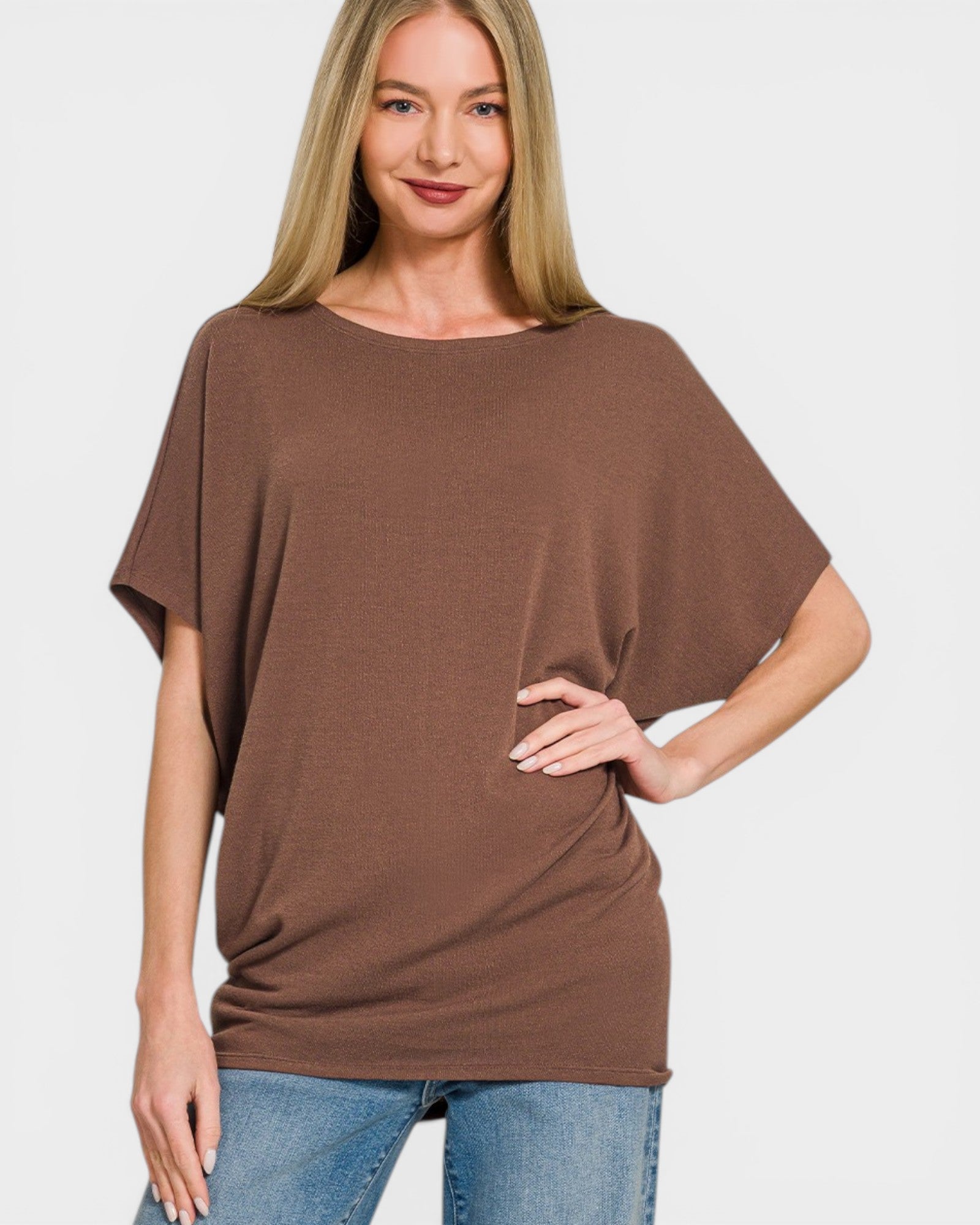 Woman wearing a brown oversized t-shirt on a white background
