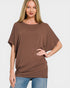 Woman wearing a brown oversized t-shirt on a white background