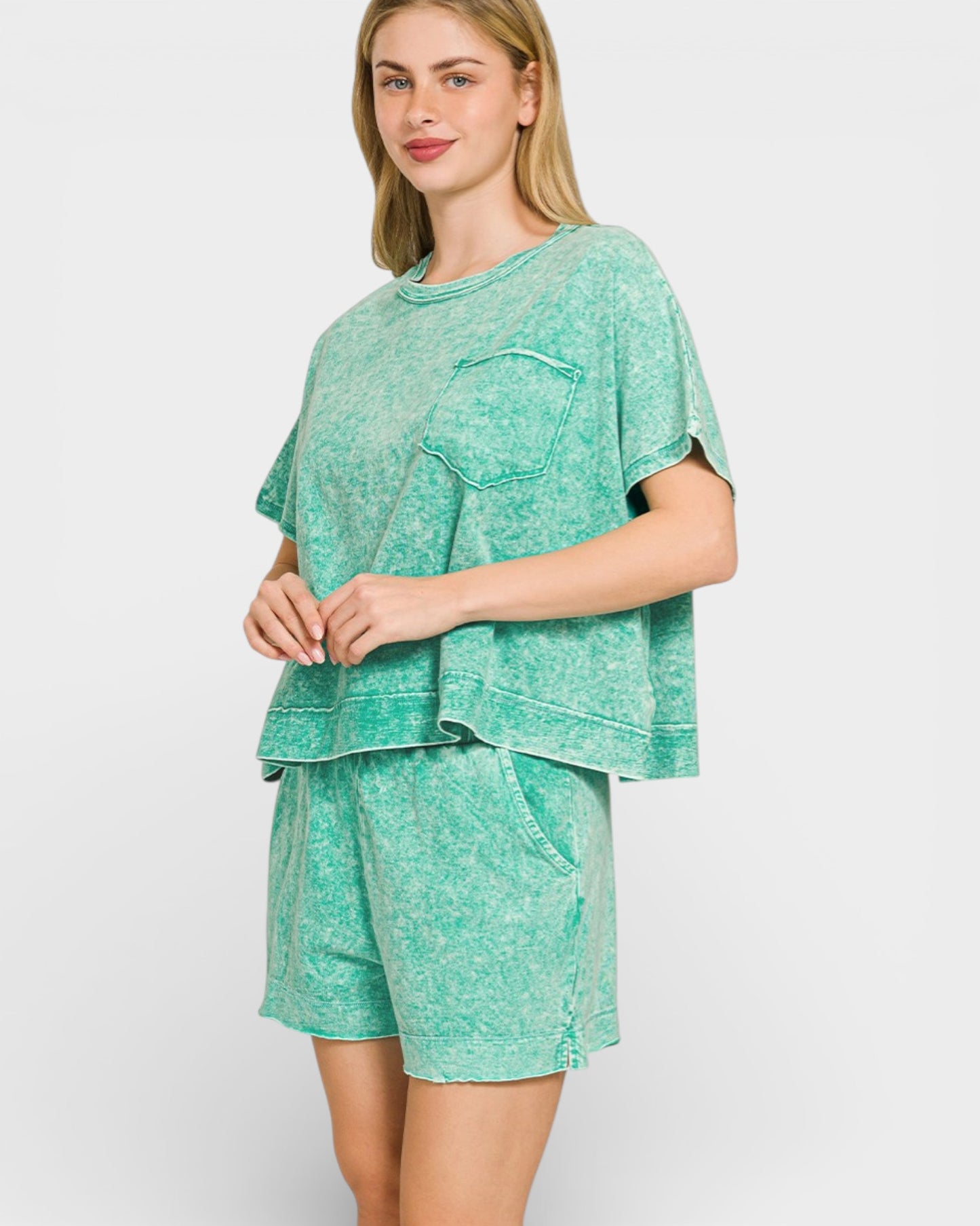 Woman wearing a green pajama set on a white background