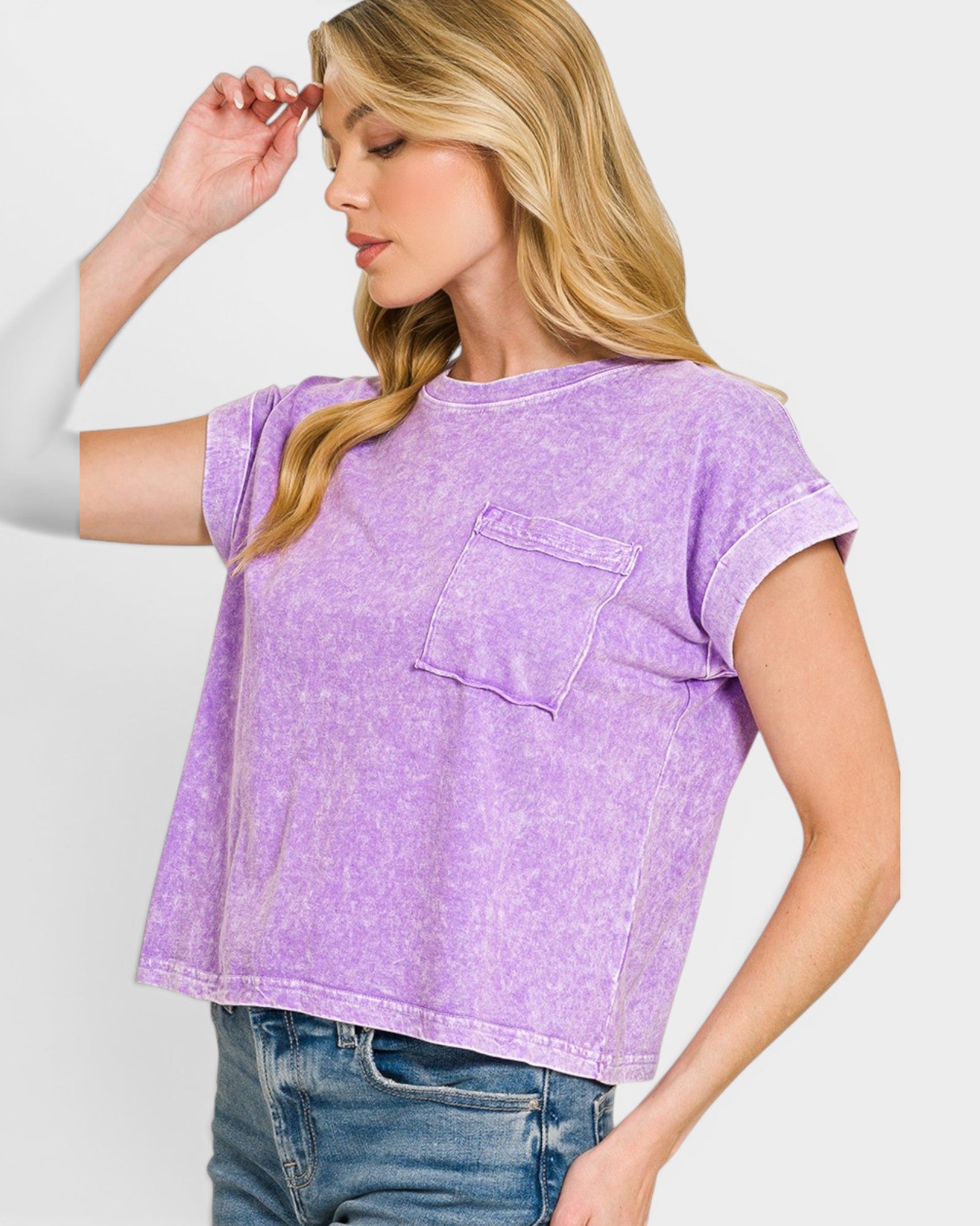 Woman wearing a purple t-shirt with a pocket on a white background