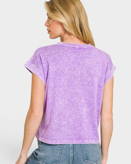Woman wearing a purple t-shirt and blue jeans on a white background