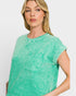 Woman wearing a green t-shirt with a pocket on a white background