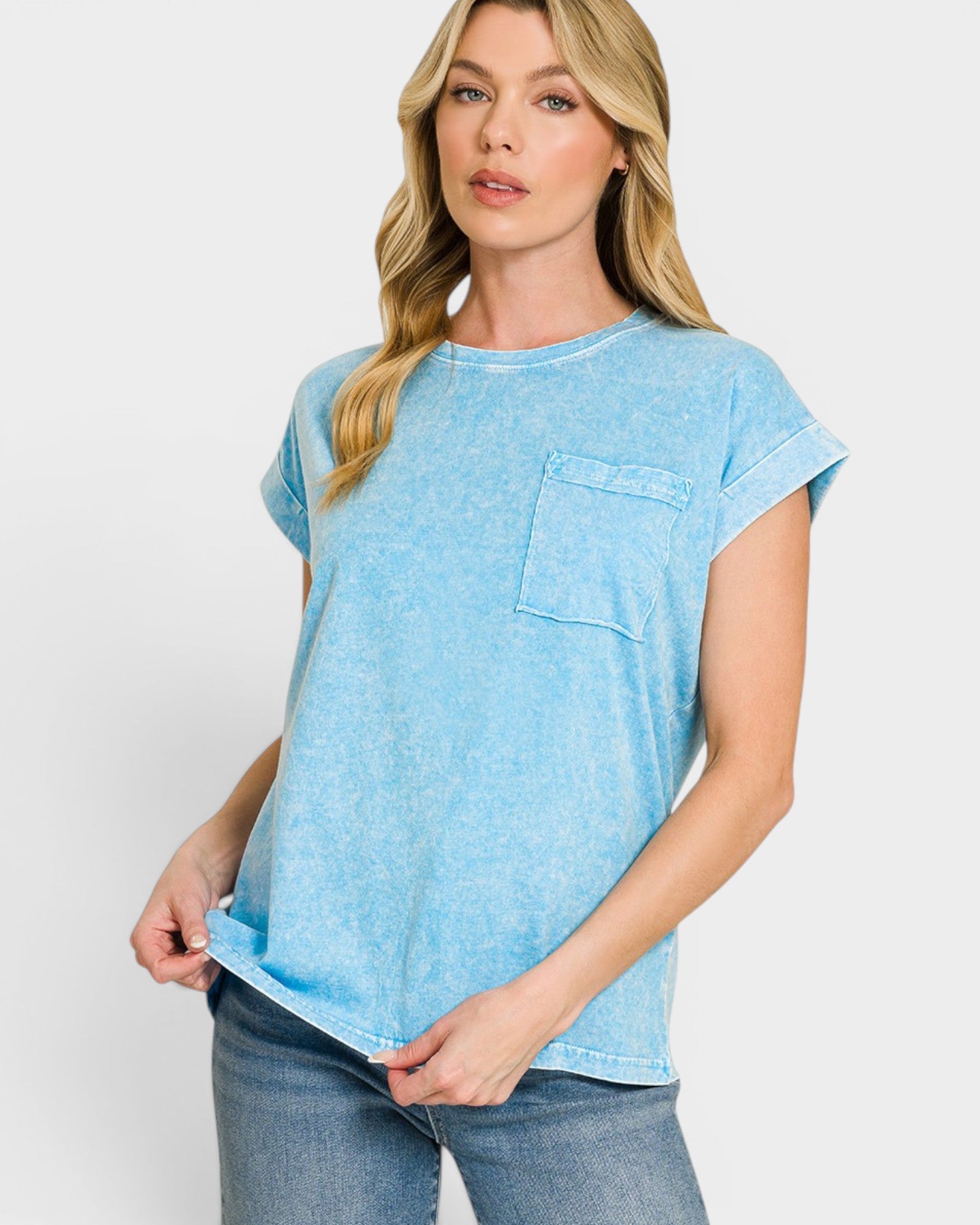Woman wearing a light blue t-shirt with a pocket on a white background
