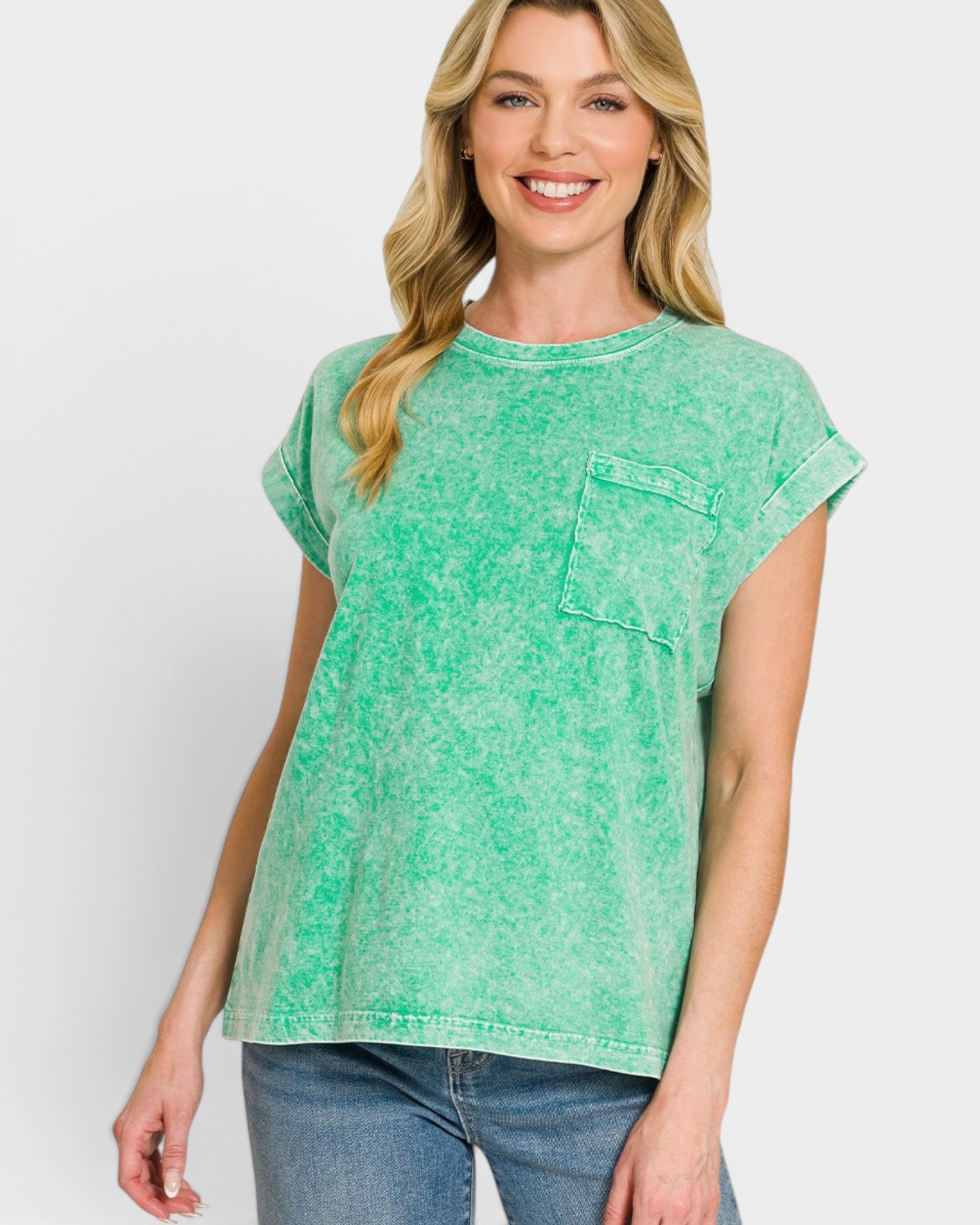 Woman wearing a green t-shirt with a pocket on a white background