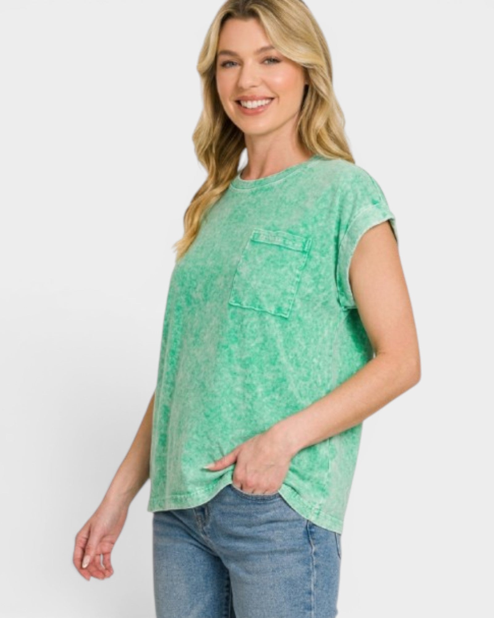Woman wearing a green t-shirt and blue jeans on a white background