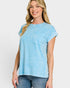 Woman wearing a light blue t-shirt with a pocket on a white background