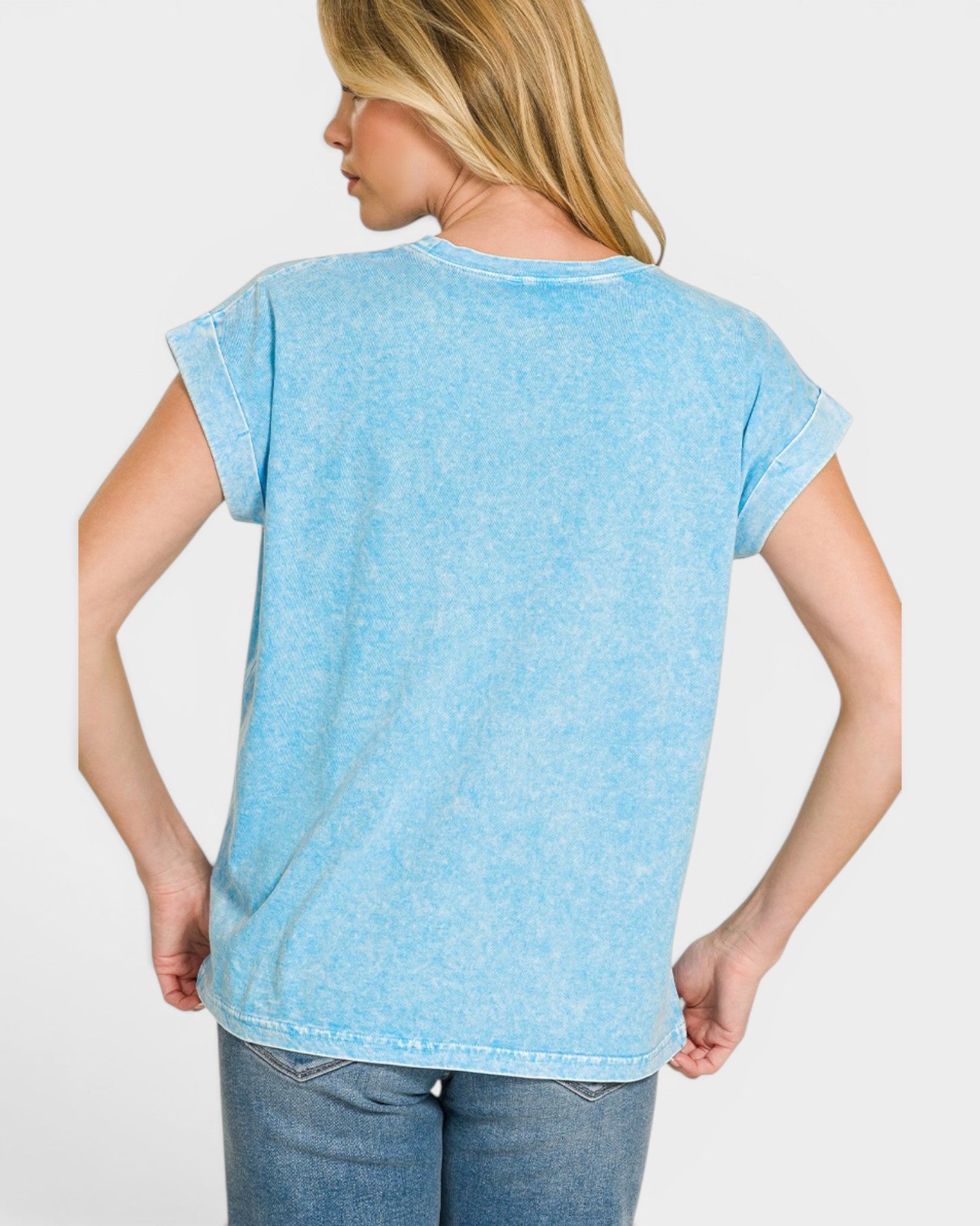 Woman wearing a light blue t-shirt against a white background