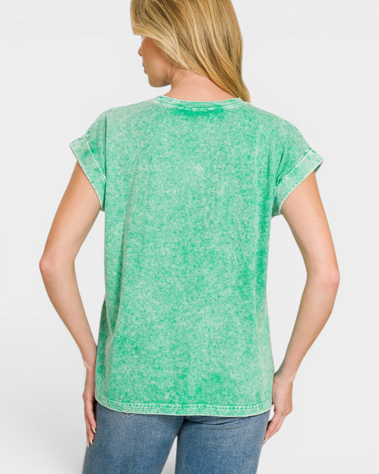 Person wearing a green t-shirt on a plain background