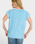 Woman wearing a light blue t-shirt against a white background
