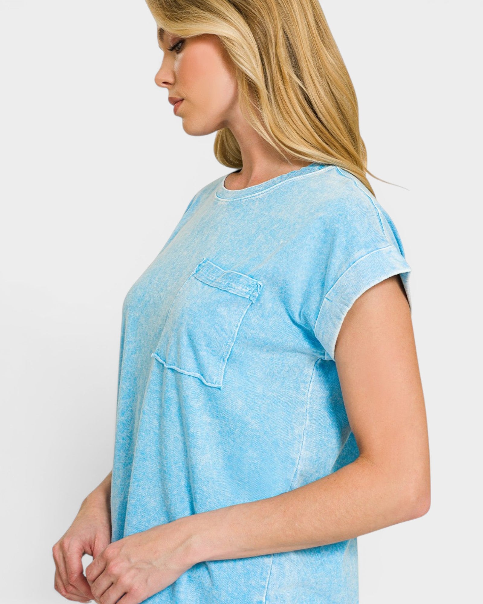 Woman wearing a light blue t-shirt against a white background