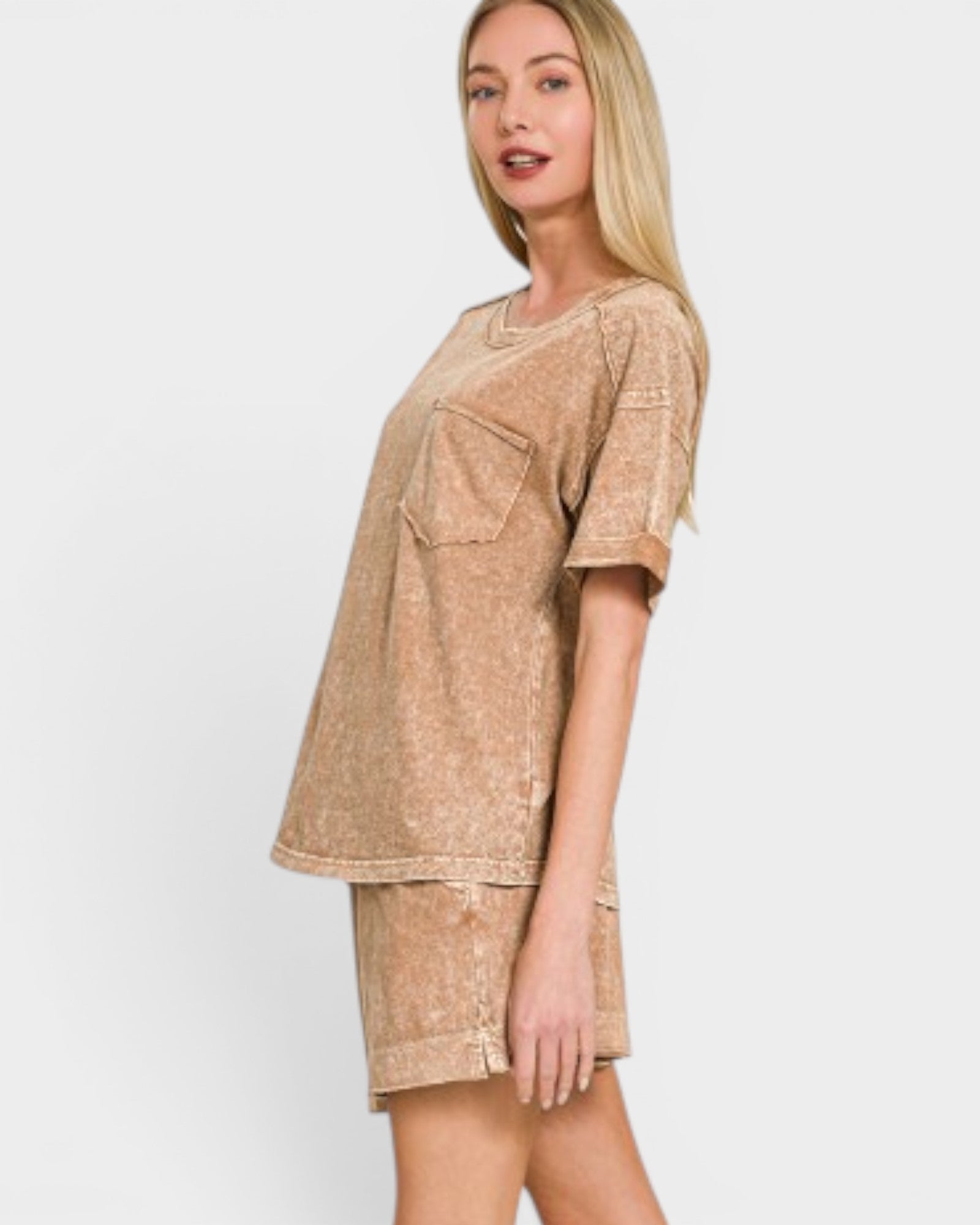 Woman wearing a beige outfit with a pocket on a white background