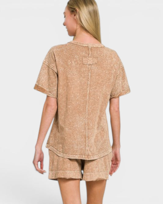 Woman wearing a beige t-shirt and shorts set on a white background
