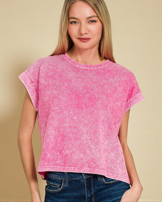 Woman wearing a pink t-shirt against a beige background