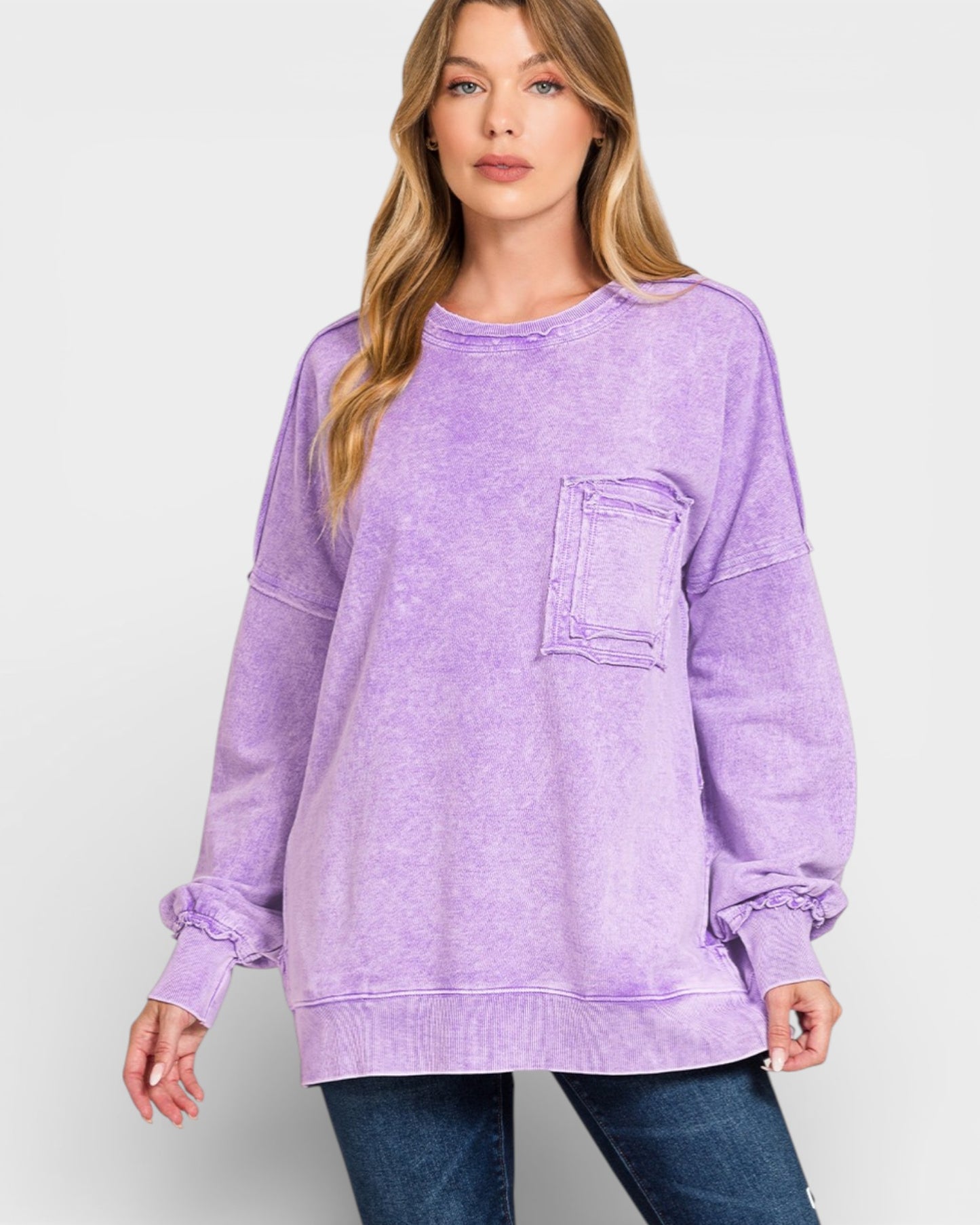 Woman wearing a purple sweatshirt with a pocket on a white background