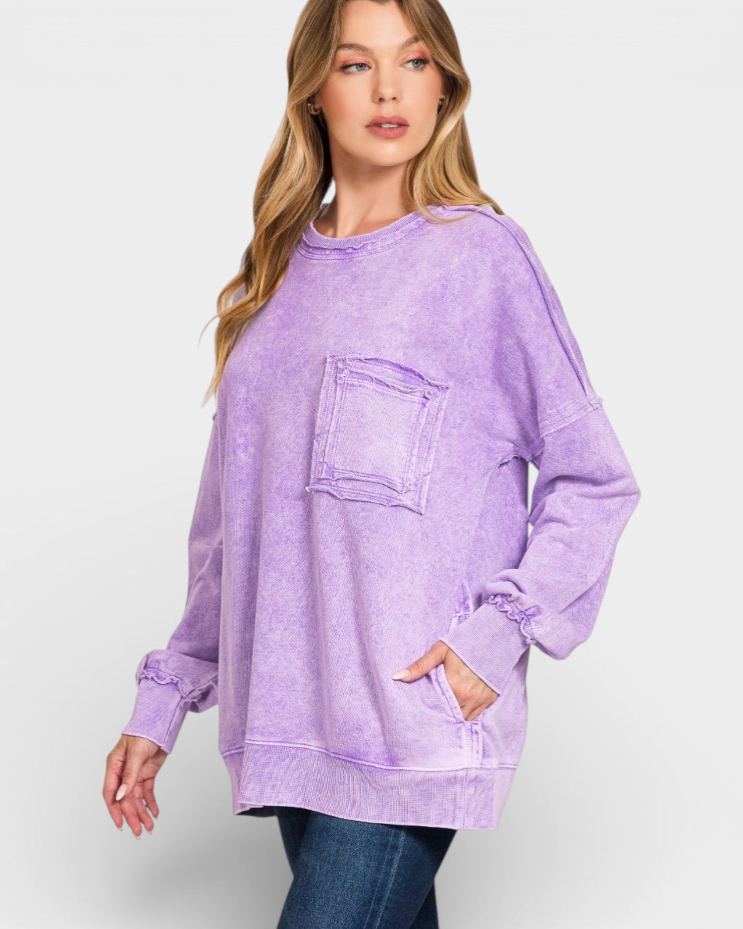 Woman wearing a purple oversized sweatshirt on a white background