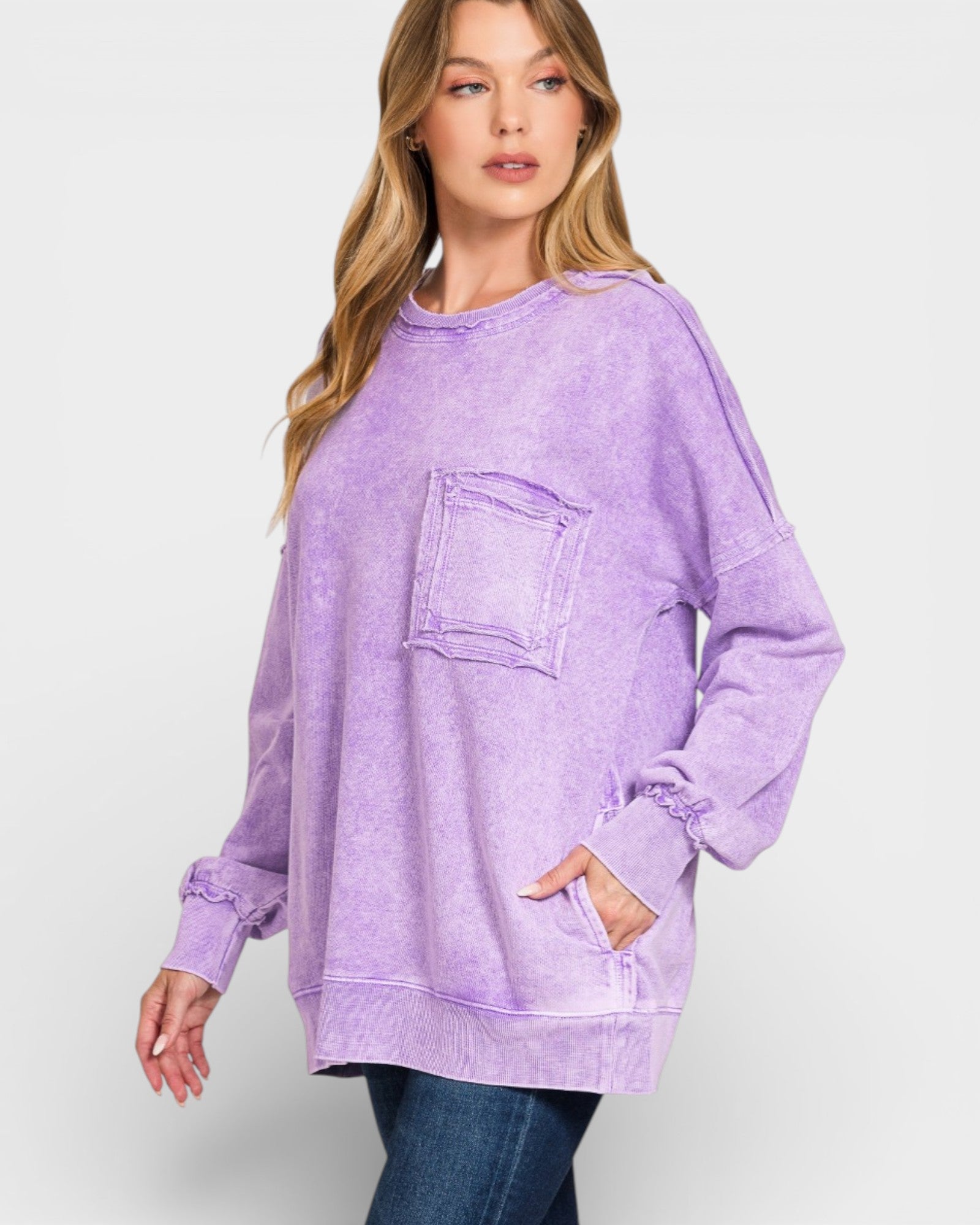 Woman wearing a purple oversized sweatshirt on a white background