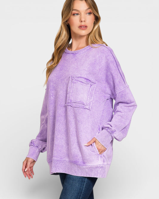 Woman wearing a purple oversized sweatshirt on a white background
