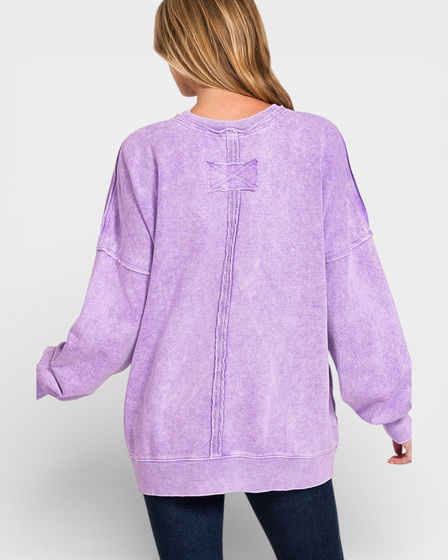 Person wearing a purple sweatshirt on a white background