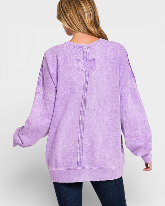 Person wearing a purple sweatshirt on a white background