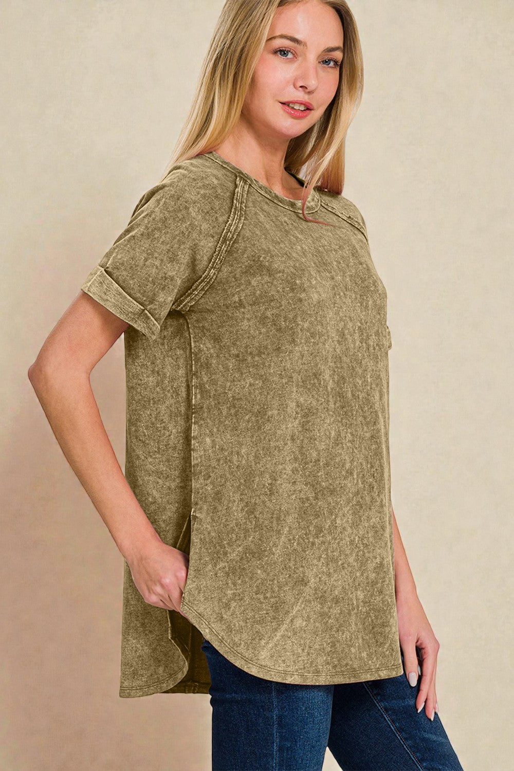 Woman wearing a green t-shirt against a beige background