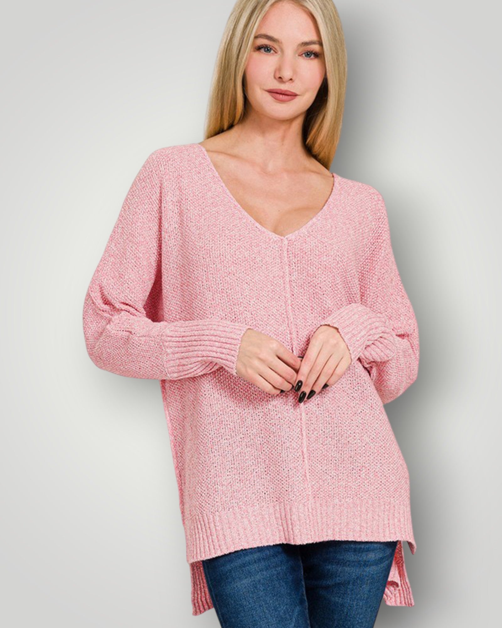 Woman wearing a pink sweater against a plain background