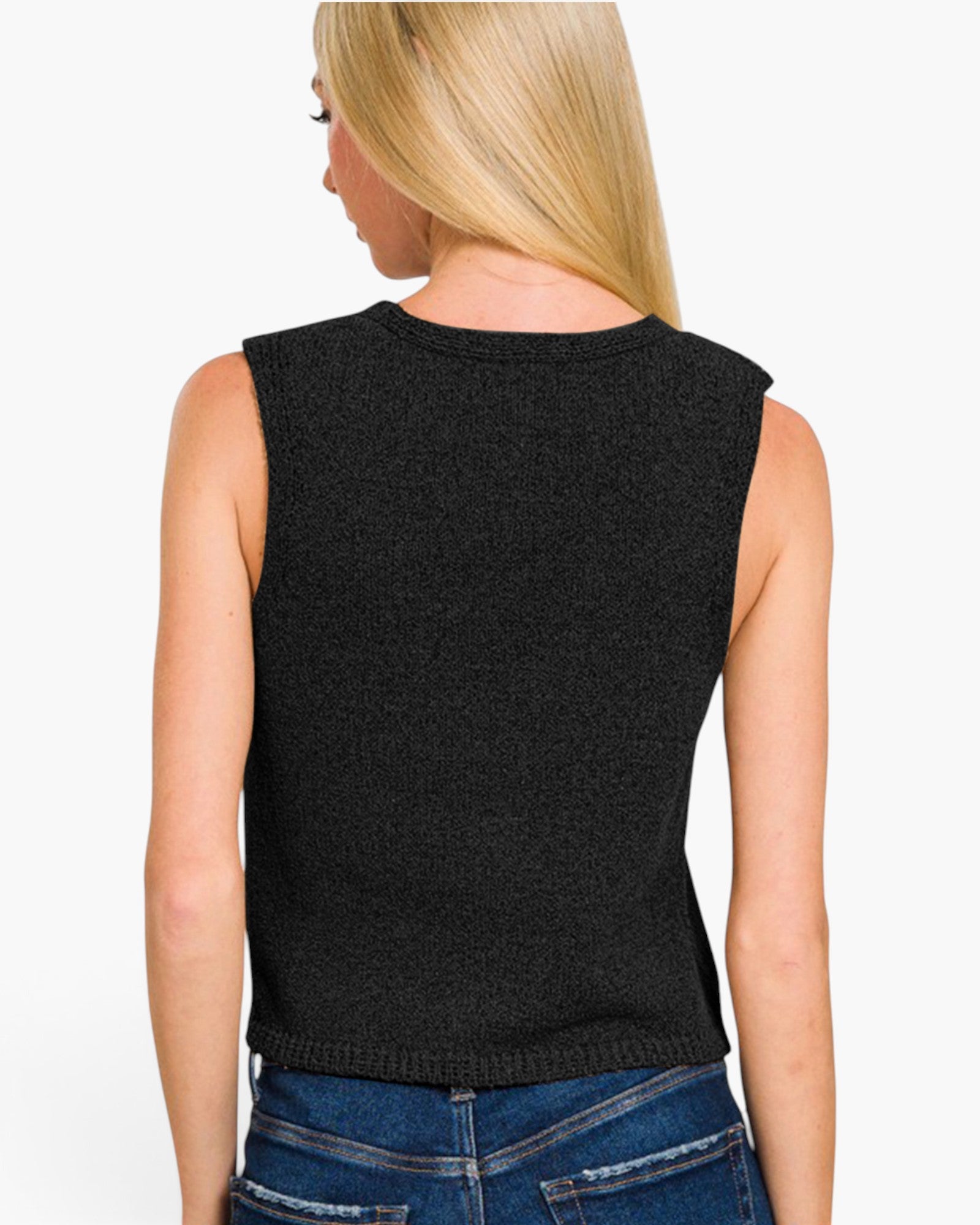 A woman shown from the back wearing a sleeveless black knit top and blue jeans against a plain white background.
