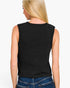 A woman shown from the back wearing a sleeveless black knit top and blue jeans against a plain white background.