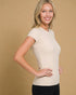 Woman wearing a beige t-shirt against a beige background