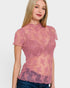 Woman wearing a pink lace top against a white background
