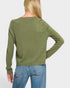 Person wearing a green sweater and blue jeans on a white background