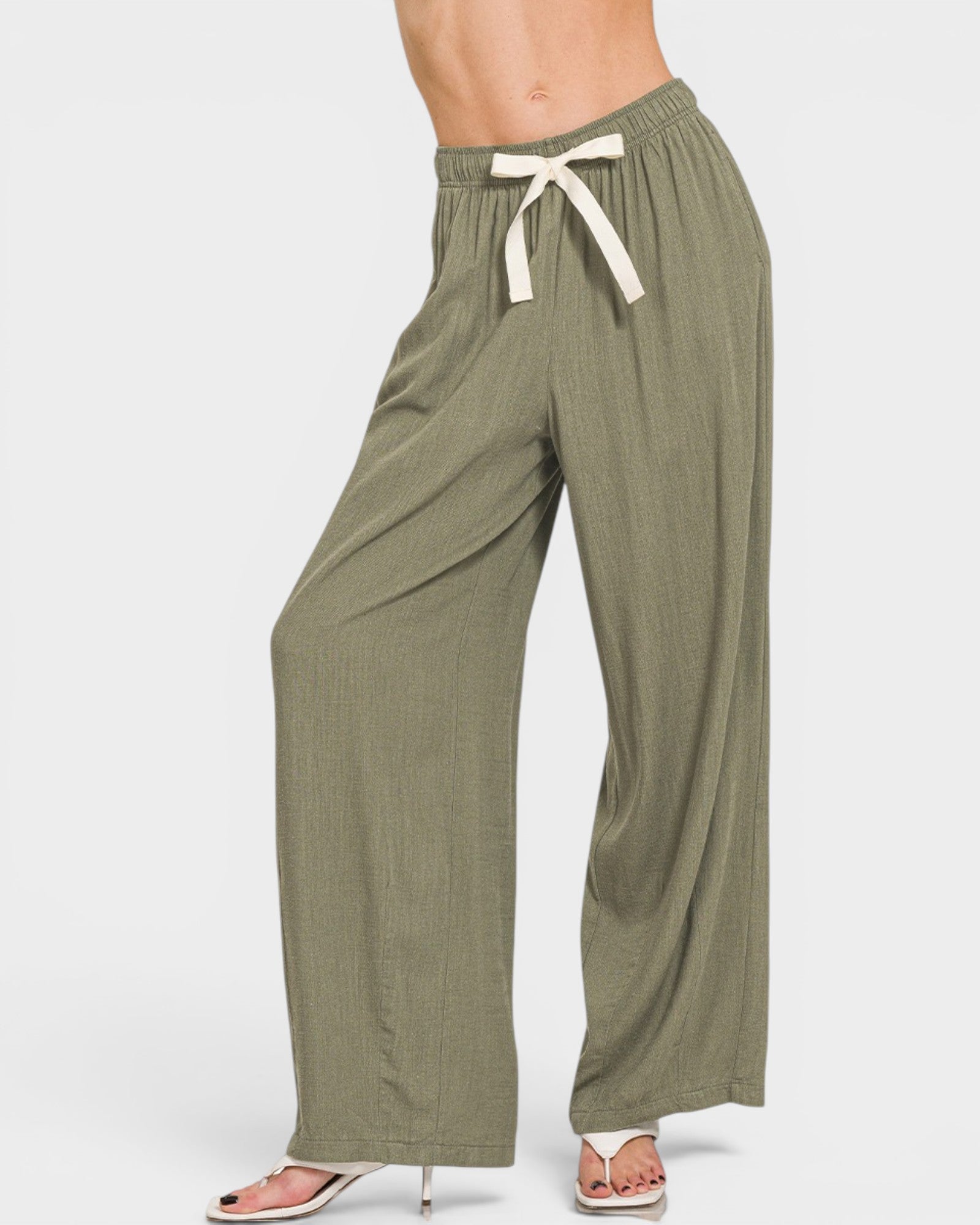 Green wide-leg pants with a white drawstring on a white background