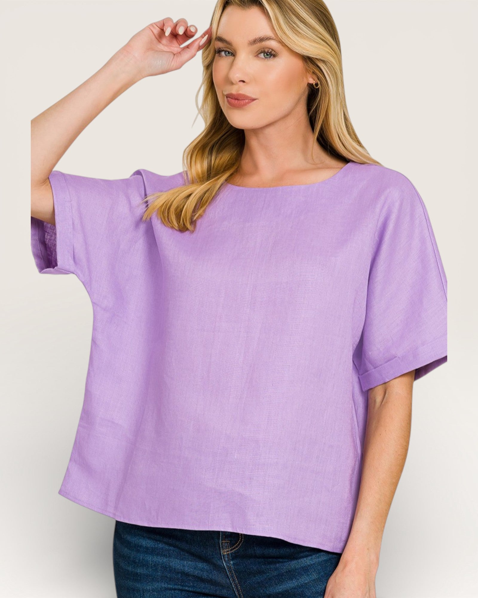 Woman wearing a purple blouse against a plain background