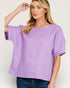 Woman wearing a purple blouse against a plain background